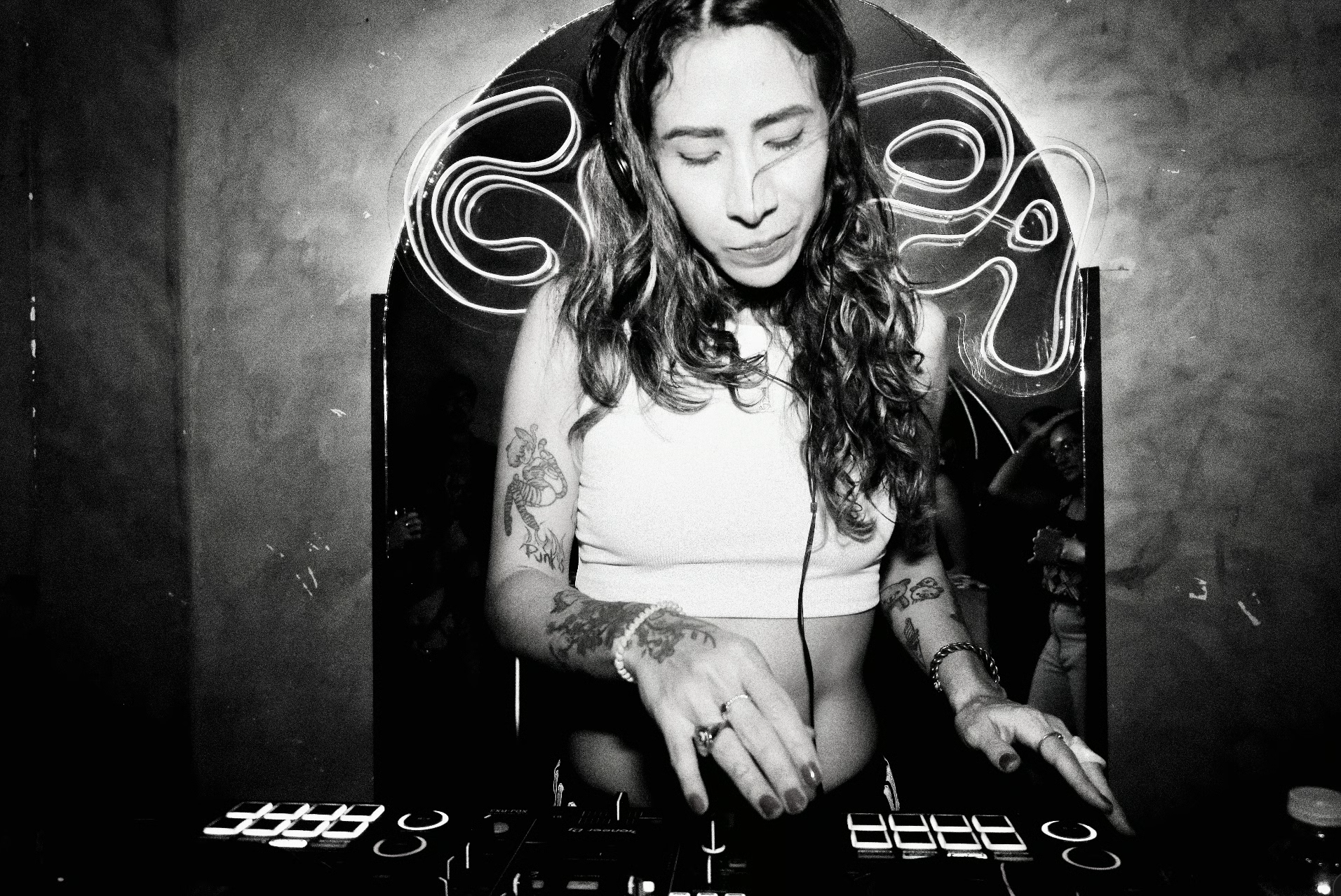 Almond DJing under neon lights